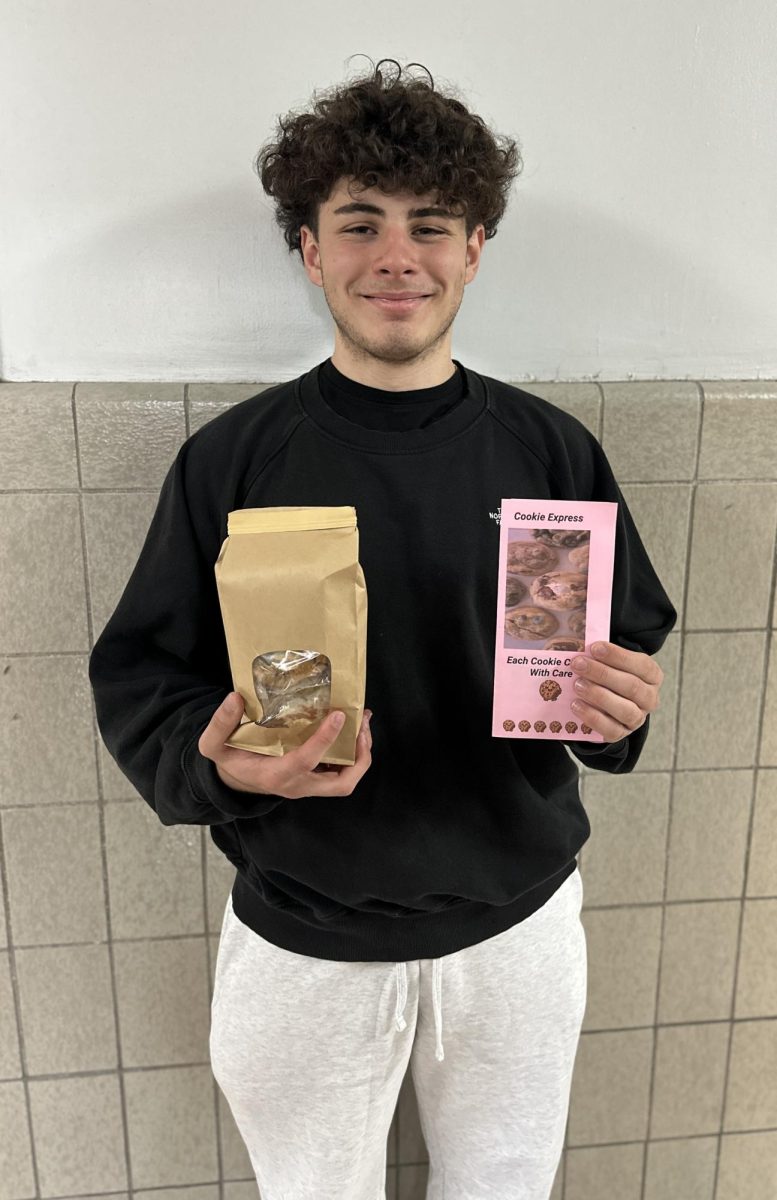 Mark Fallah proudly displays the brochure for his business and a bag of his home-baked cookies.